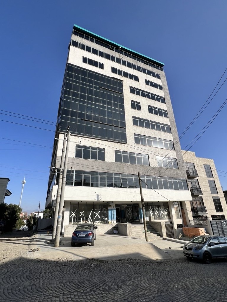 CMC commercial mid-rise — stone-glass facade